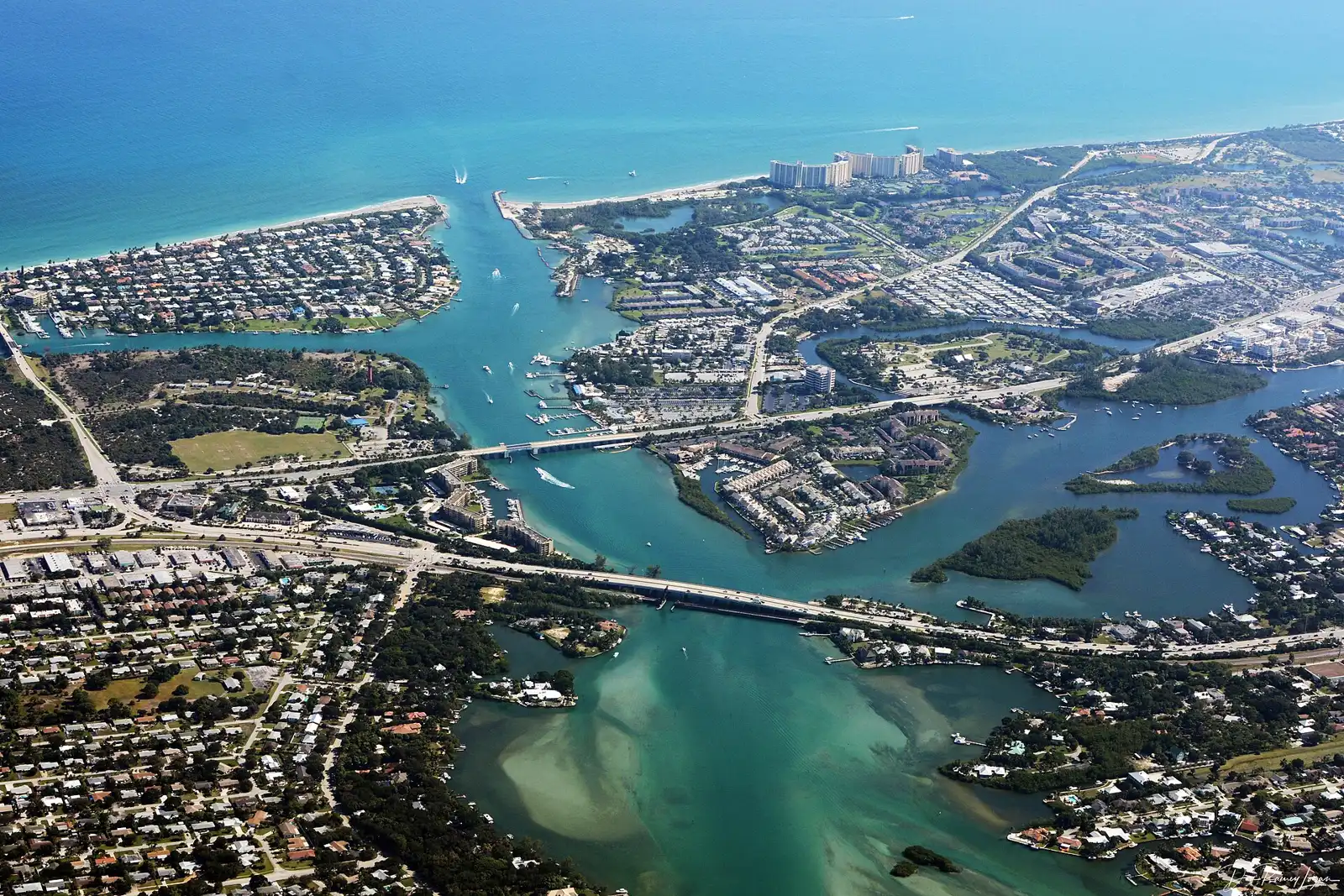 An aerial view of the Jupiter Inlet, the Loxahatchee River and the U.S. 1 bridge, with the waterfront where Harbourside Place sits.