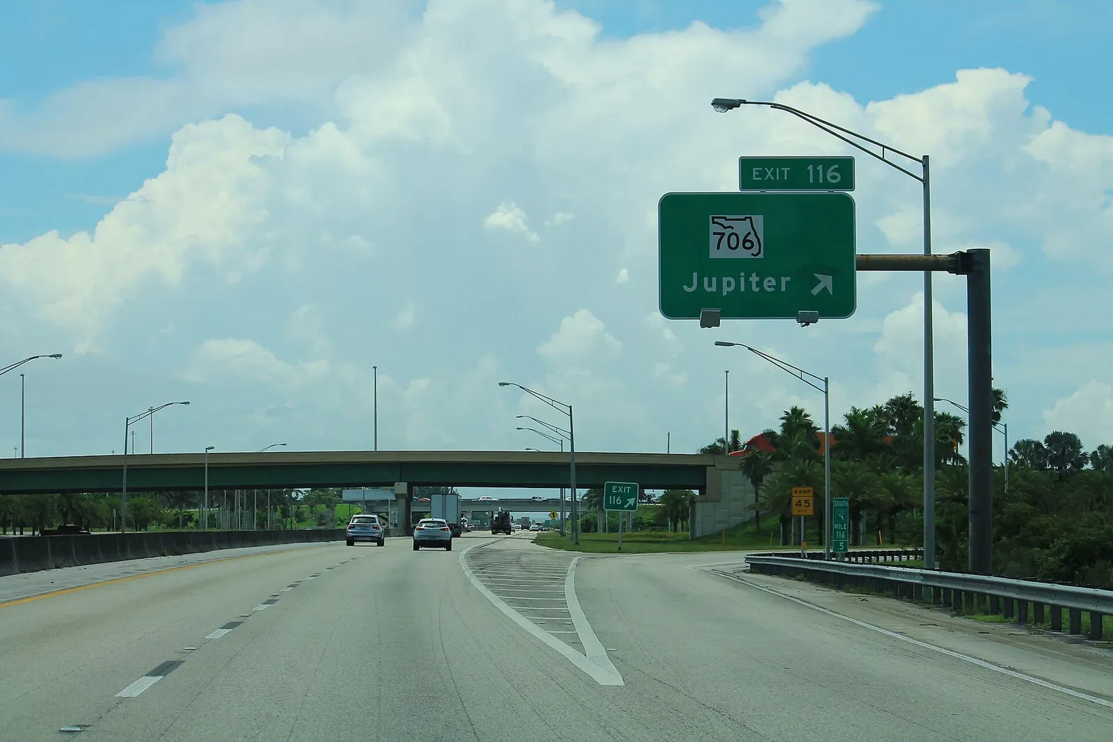 A southbound Florida's Turnpike sign for the State Road 706 exit to Jupiter.