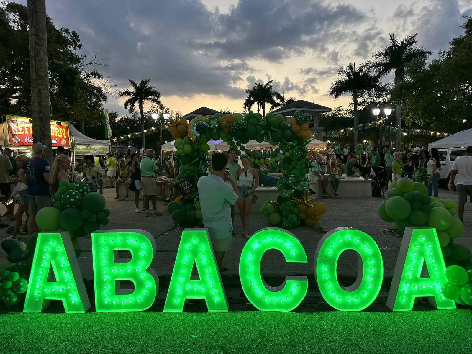 Lighted letters spell out Abacoa in front of the crowd and food stands at Abacoa Town Center during the Irish festival.