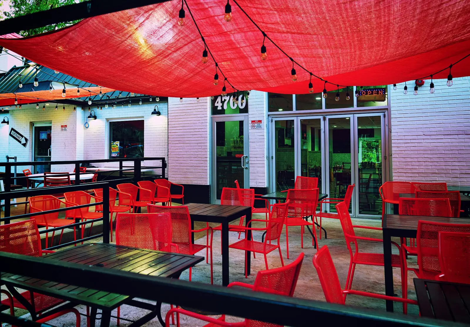 Tables and chairs on a sidewalk cafe patio. The photo was not taken in Jupiter.
