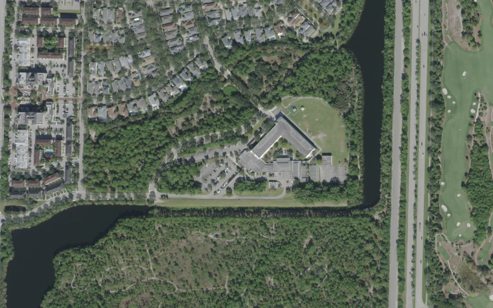 Beacon Cove Intermediate off School House Road in south Jupiter, ringed by a lake and woods, seen from the air