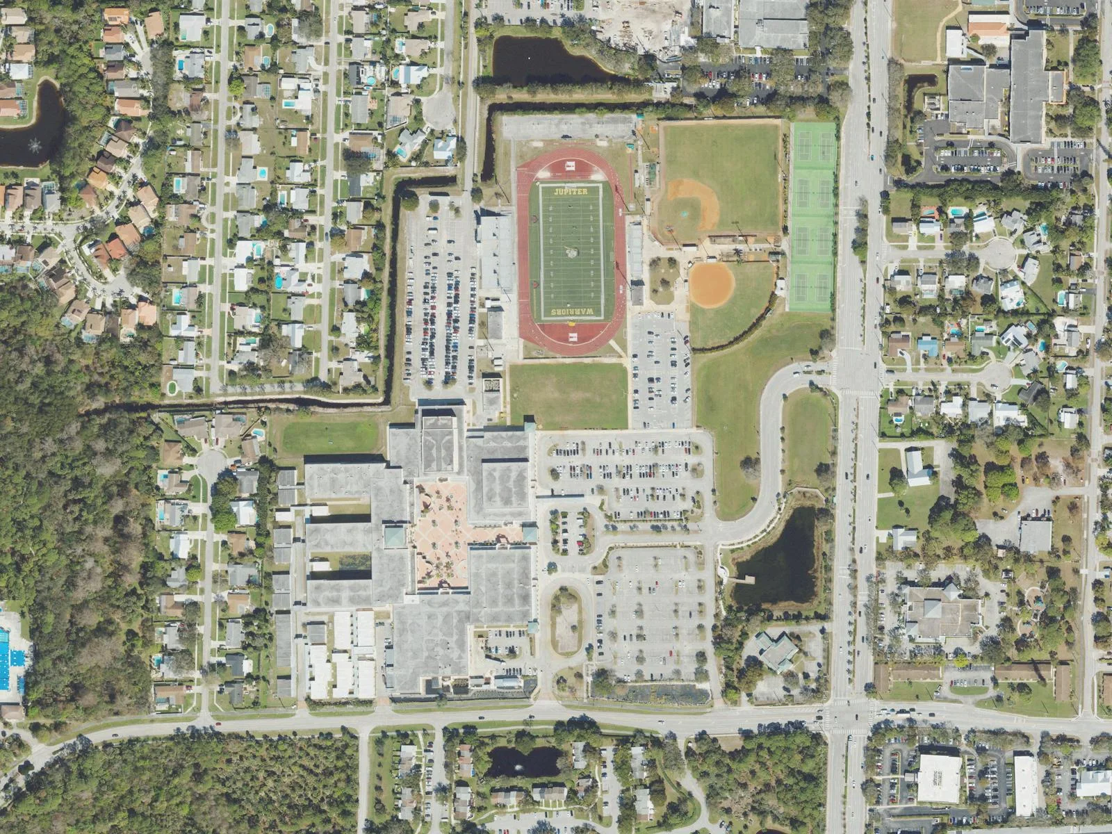 Jupiter Community High's campus and Warriors stadium on Military Trail, seen from the air.