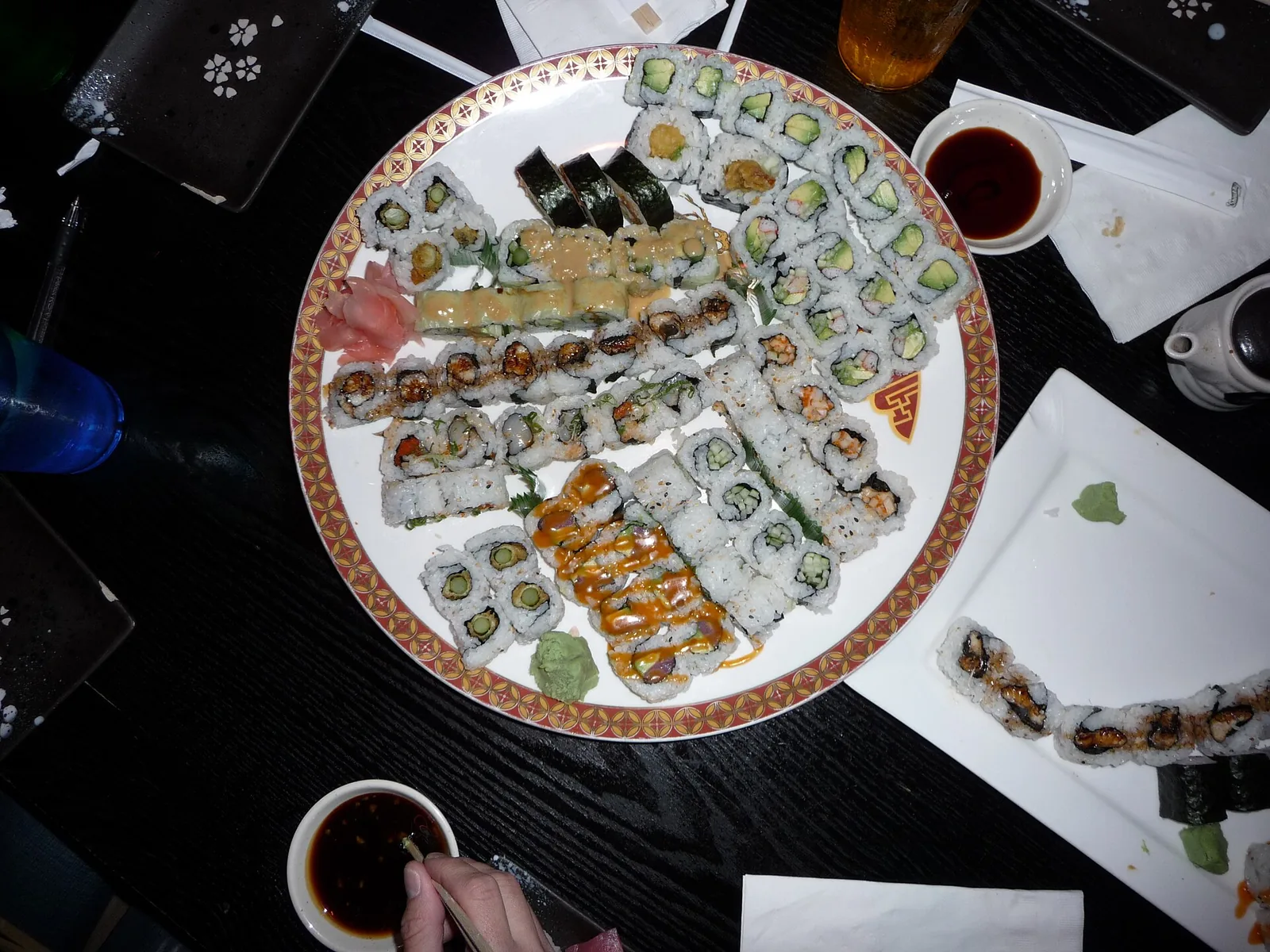 A platter of assorted sushi rolls with soy sauce. The photo was not taken at a Jupiter restaurant.
