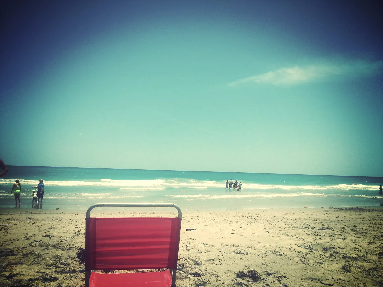 A beach chair on the sand facing the Atlantic at Carlin Park in Jupiter.